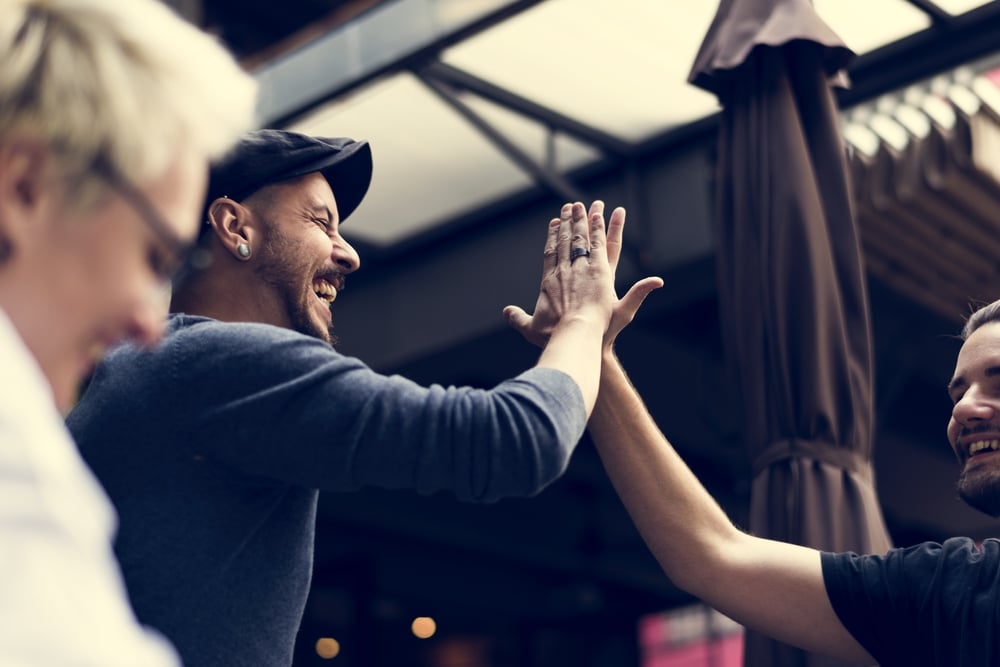 Men high-fiving each other
