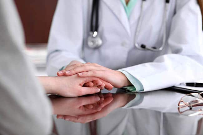 Doctor holding a patient's hand