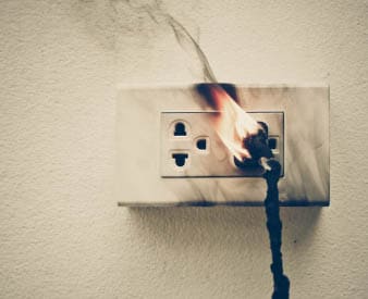 Cord in wall socket on fire
