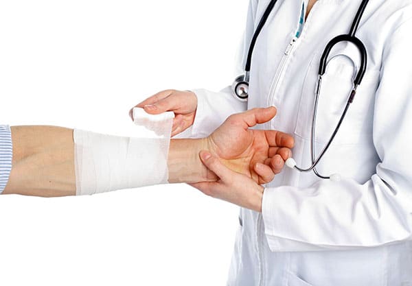 Doctor wrapping broken wrist