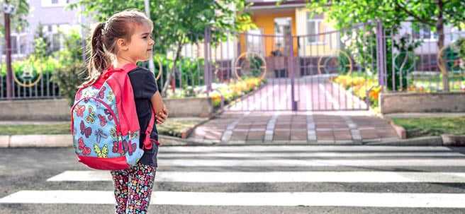 Child looking both ways before crossing the road