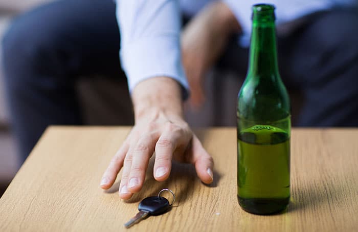 Man reaching for car keys after drinking