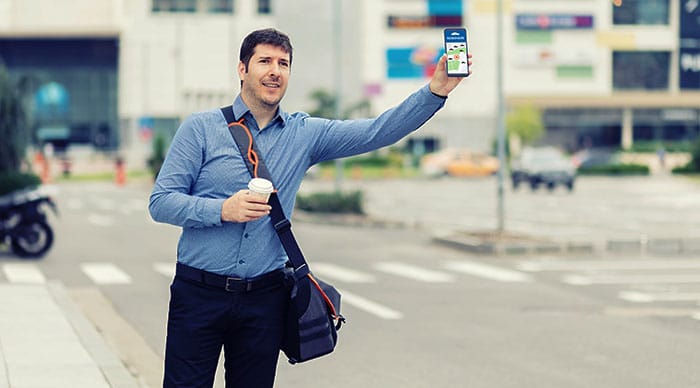 Man waving down rideshare driver