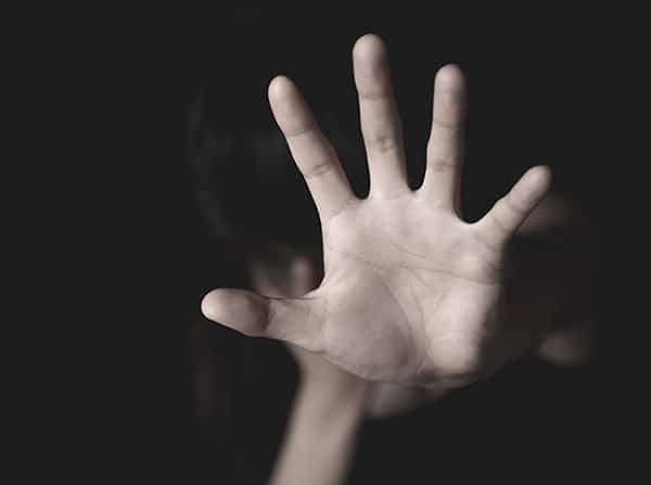 Assault victim holding hand up