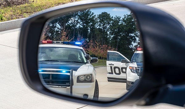 Police cruisers in mirror view