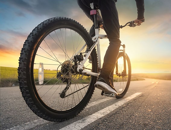 Man riding bike down road