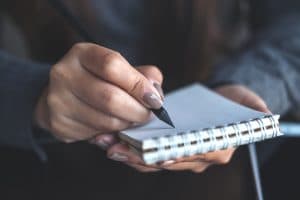 Person documenting the accident on a notepad