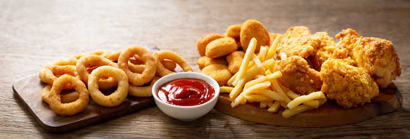 plate of deep fried foods with red dipping sauce