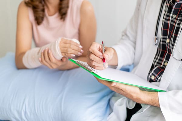 Women with broken bone injury in doctor examination
