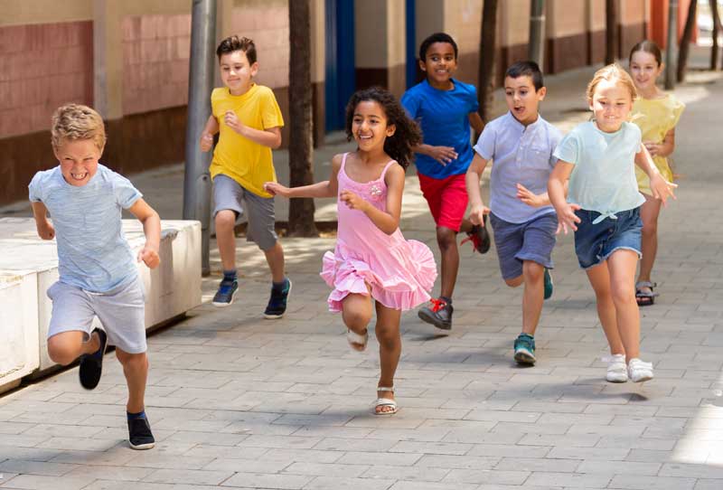 children racing down school walkway