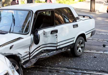 white car hit by another oncoming vehicle