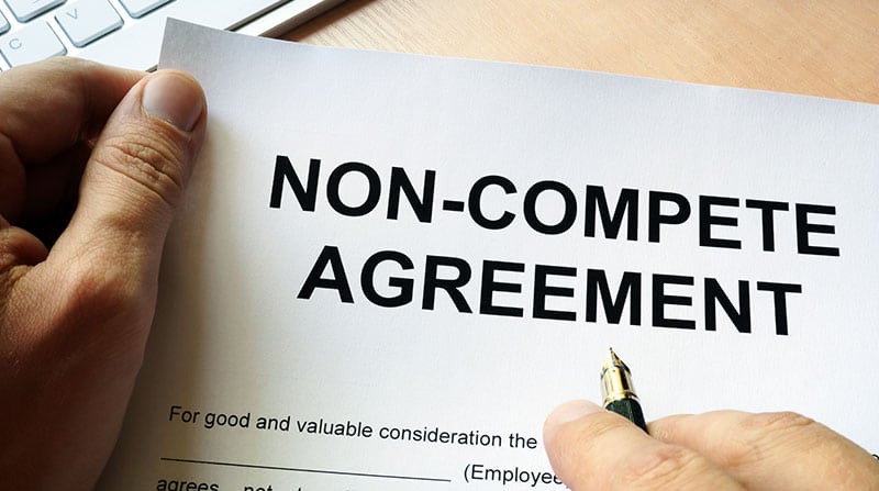 Non-compete agreement in hand