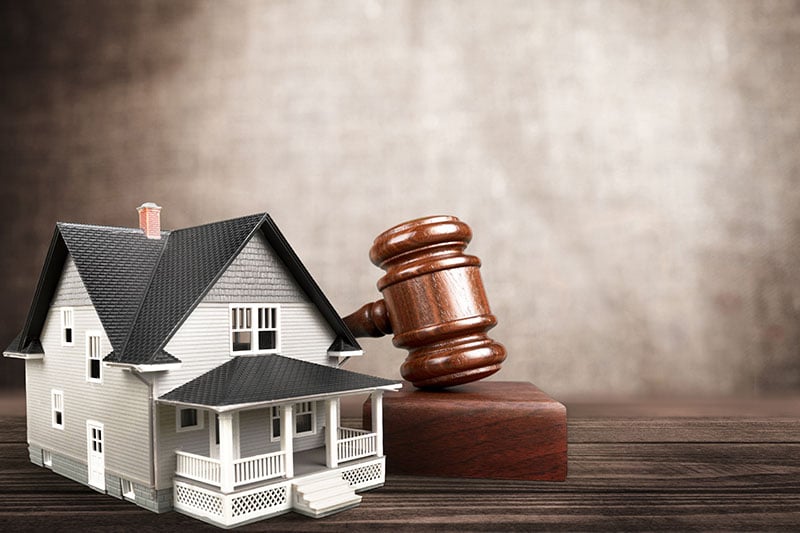 Gavel next to model house