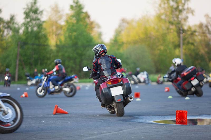 Motorcycle riders navigating training course for license