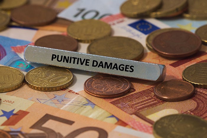 "Punitive Damages" printed on metal bar