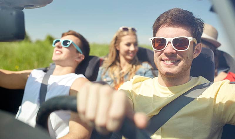 Group of teens driving on road trip