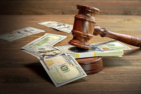 Judge's gavel over stack of cash