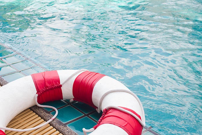 Life guard floating ring on side of swimming pool