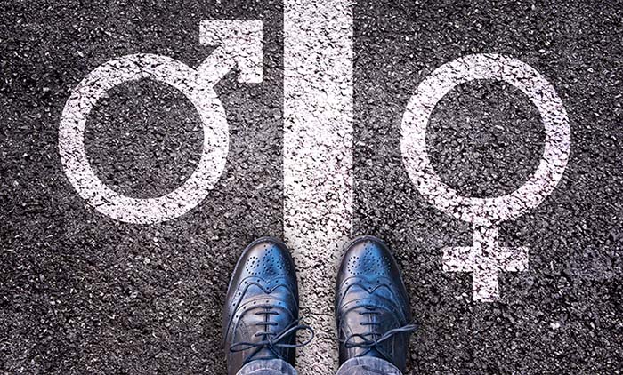 Employer standing in between symbols of male and female