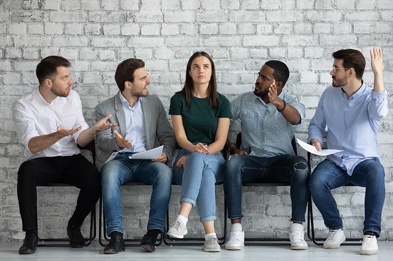 Group of male employees harassing female employee
