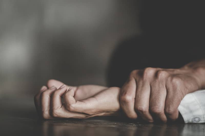 Man holding woman's hand