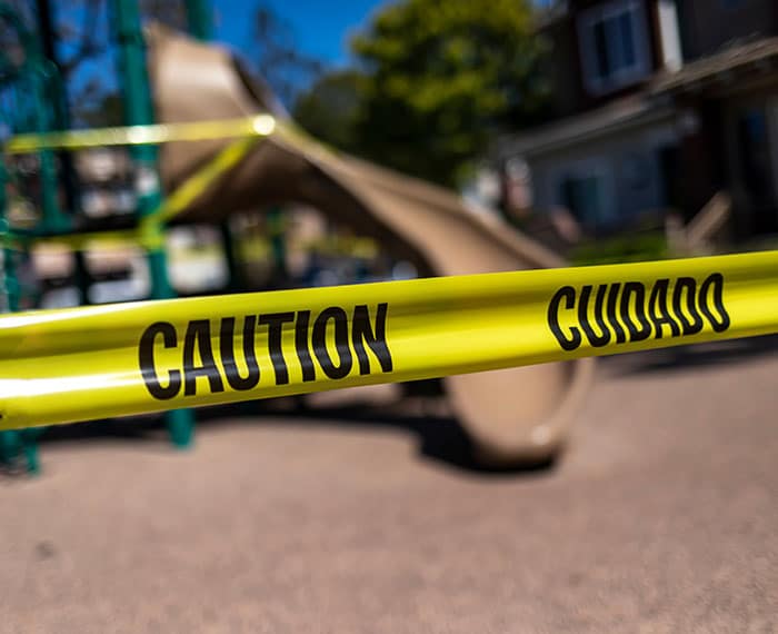 Yellow caution tape surrounding dangerous playground