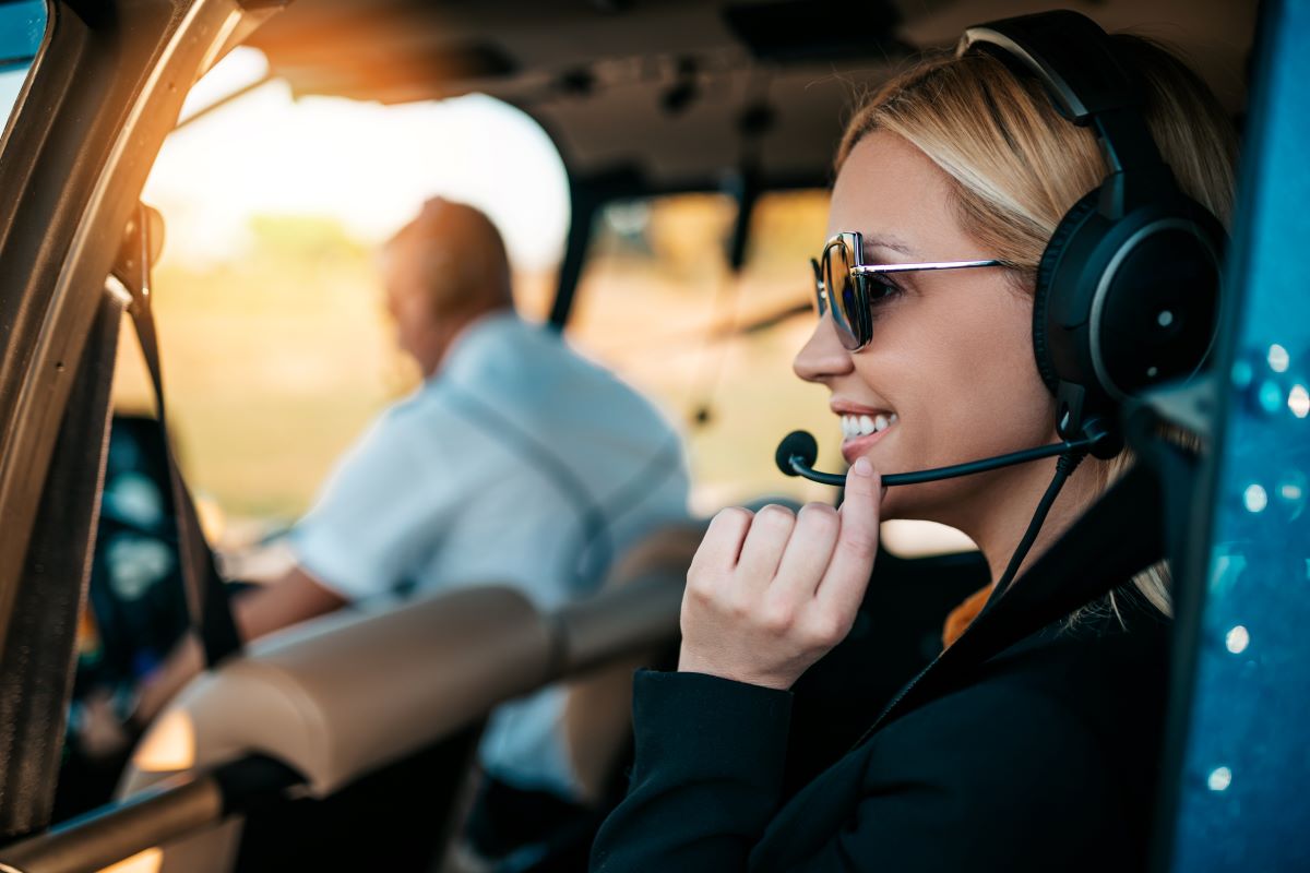 Female passenger in helicopter wearing a headset