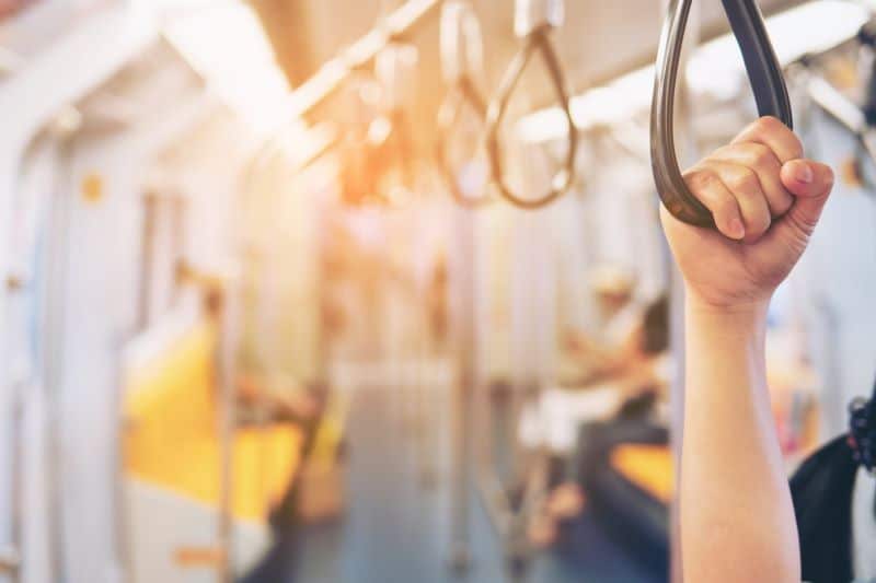 Persons hand holding a loop on a transit bus
