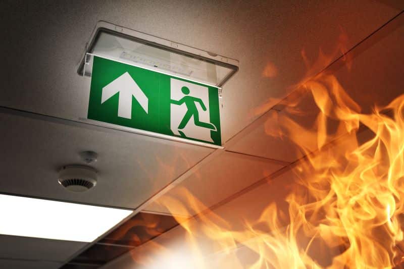 Green exit sign in building that's on fire