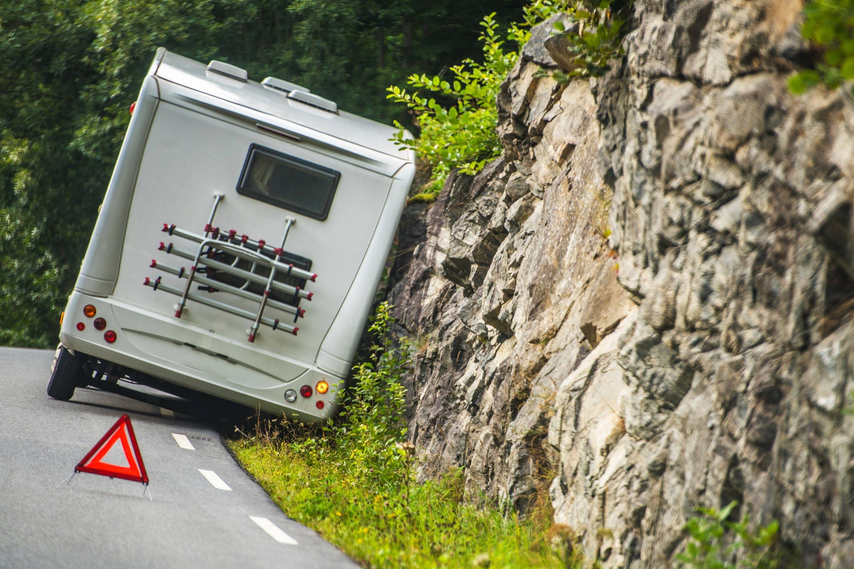 RV trailer stuck on the side of a paved road