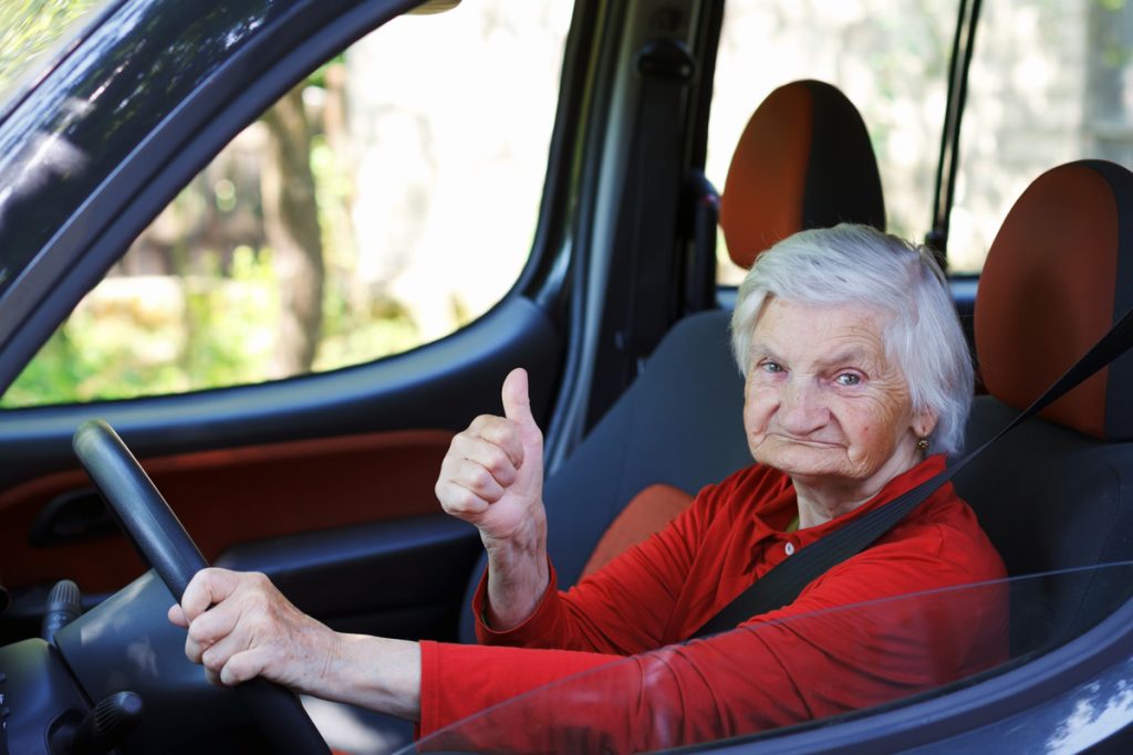 senior driver giving thumbs up