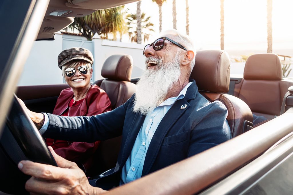 seniors driving a convertible