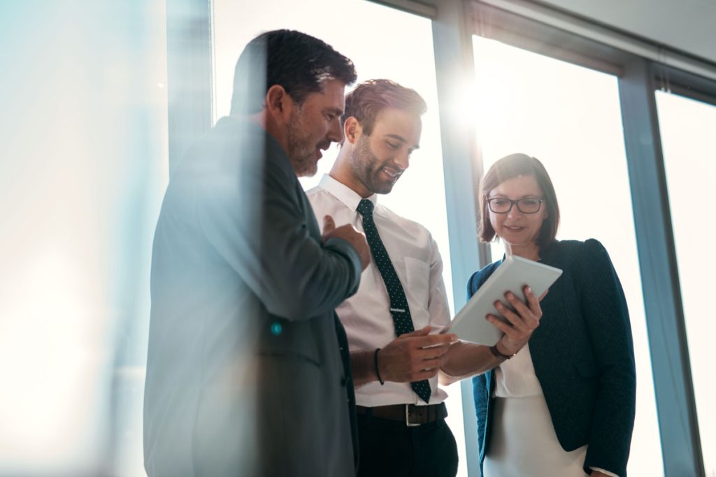 coworkers smiling looking at a document