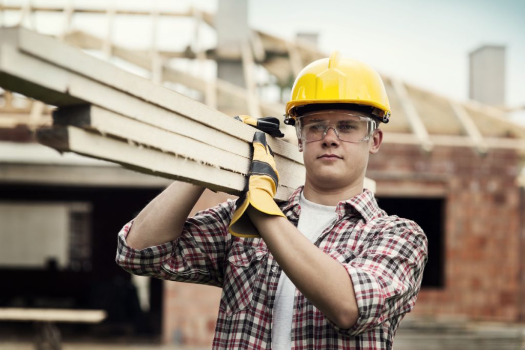 construction worker carrying wood